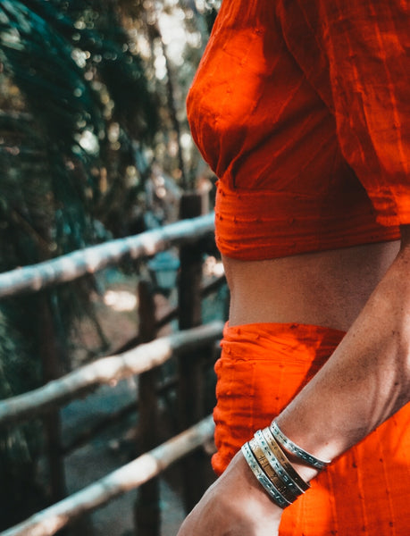 variety of silver & brass hand stamped bracelets, on model