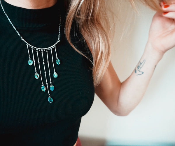 7 cascading abalones on silver bars, on model