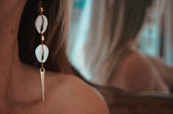 gold spiked cowrie earrings, on model