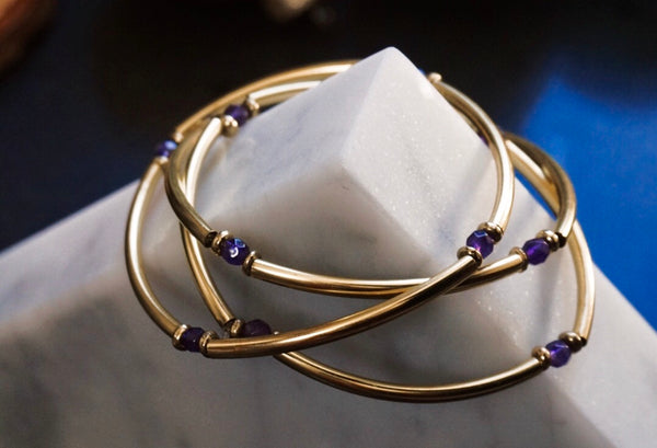 stretchy, gold tube bar bracelets, amethyst beaded in between