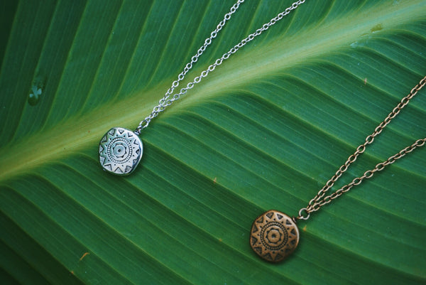 zoomed in on the layered necklace details, one silver accented, other bronze accented, product image