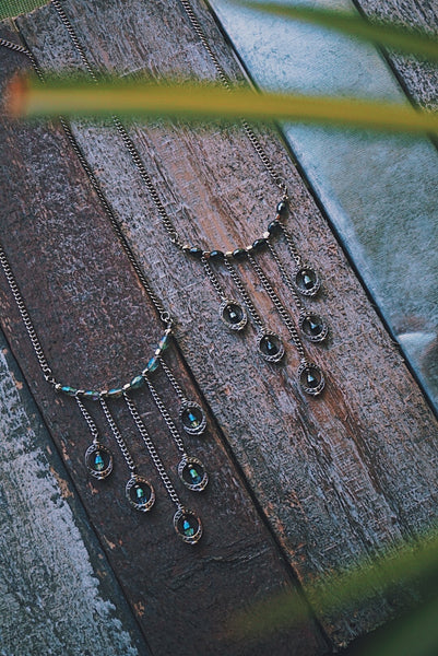 silver statement necklaces, light blue crystals, navy crystals, gradually falling, on wood