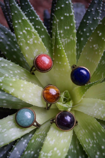 variety of semiprecious stone rings, bronze, adjustable base, aventurine, tigers eye, gold sandstone, blue sandstone, amethyst, rings