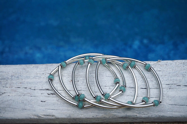 stretchy, silver tube bar bracelets, turquoise beads in between