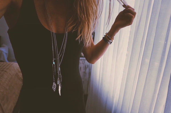 variety of silver lariats, adjustable, long necklaces, on model