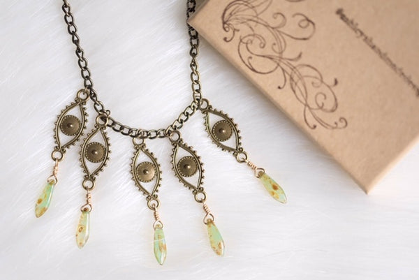 bronze eyes with turquoise picasso beads, necklace, flat lay, product image