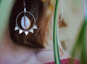 silver Shell Burst earrings, close up image, product on model